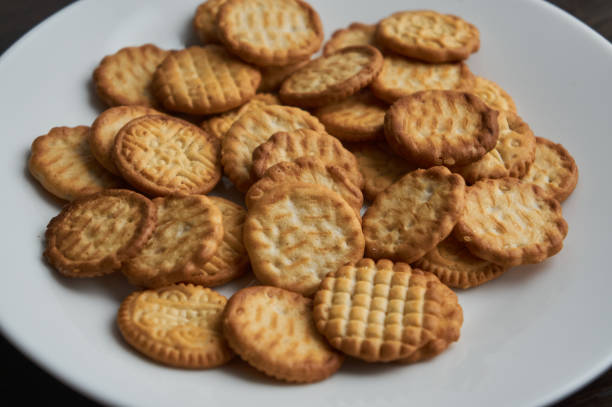 istock Small round dry baked cookies  on white plate 1313869642