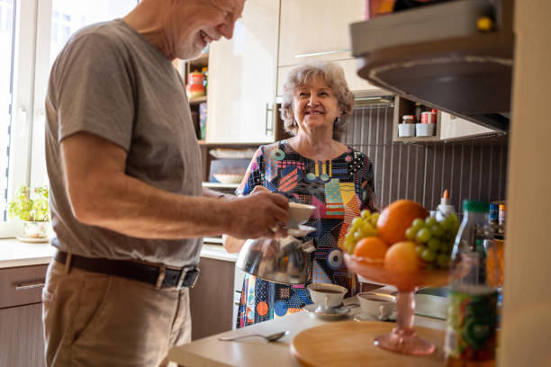 istock Senior couple together in their kitchen at home 1313876869