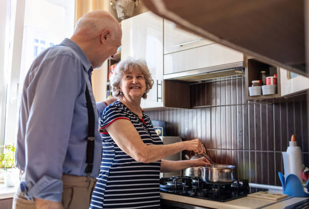 istock Senior couple together in their kitchen at home 1313877049