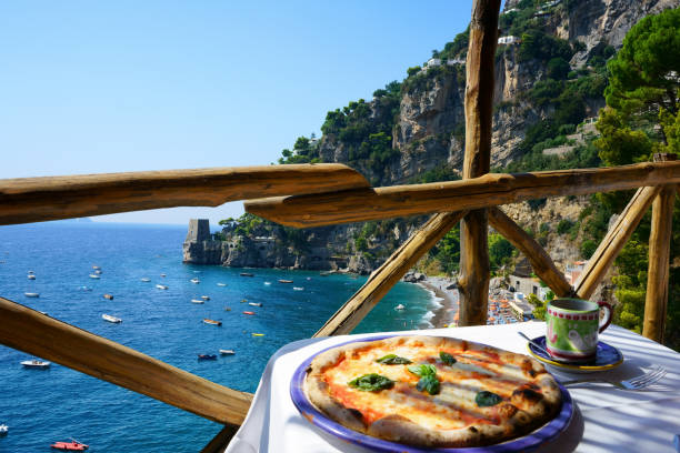 Pizza place terrace overlooking to a beautiful Positano coast, Italy Pizza place terrace overlooking to a beautiful Positano coast, Italy amalfi food stock pictures, royalty-free photos & images