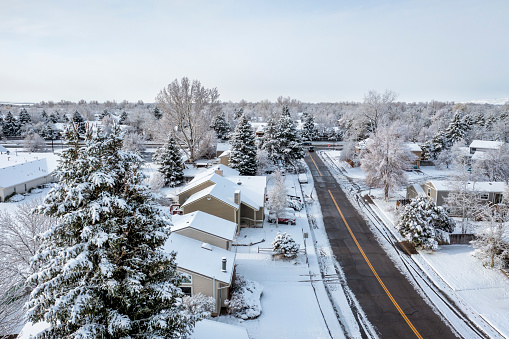 street in a residential area of Fort Collins in northern Colorado after springtime snowstorm, aerial view