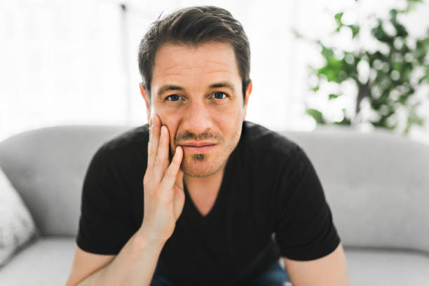 istock Depressed man thinking at home on couch 1313877098