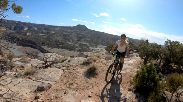 istock First person perspective of mountain biking desert pathway, over rocks 1313882446