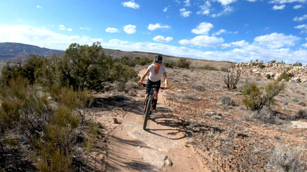 istock First person perspective of mountain biking desert pathway, over rocks 1313882447