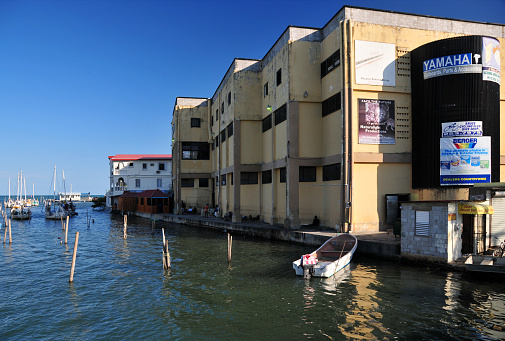 Belize City, Belize: Haulover Creek as it reaches the Caribbean sea - the center of the city, Southside buildings and pier.
