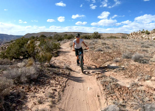 istock First person perspective of mountain biking desert pathway, over rocks 1313882518