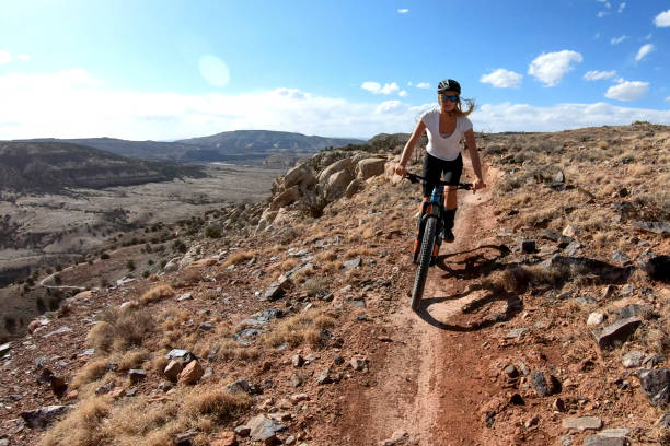 istock First person perspective of mountain biking desert pathway, over rocks 1313882612