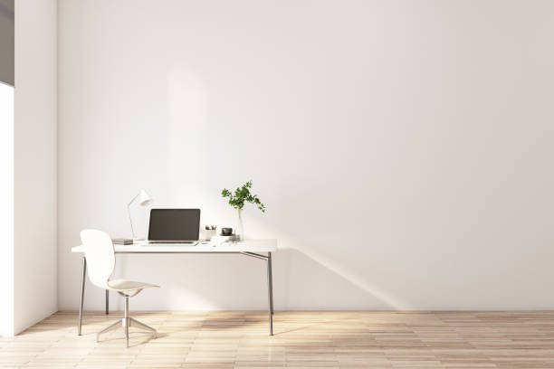 istock Stylish work place with modern laptop on white table, white chair near on light wall background 1313883313
