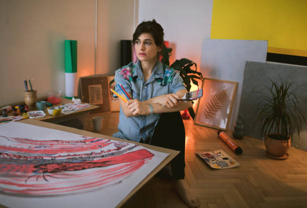 istock Female artist paint on canvas in studio 1313883448
