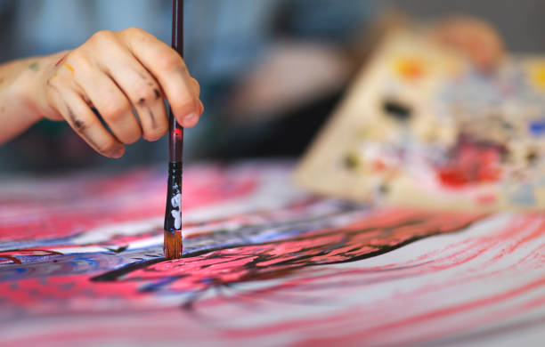 istock Female artist paint on canvas in studio 1313883515