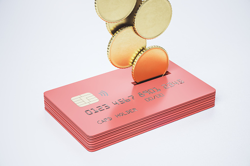 Return money and cash back concept with metal coins bound for a stack of red credit cards on abstract light surface. 3D rendering