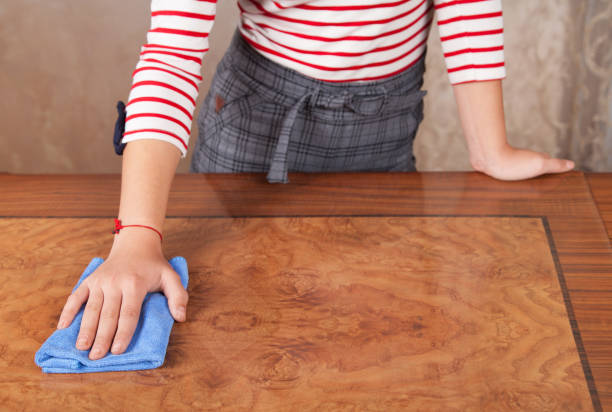 istock Woman cleans the table with a cloth. 1313883752