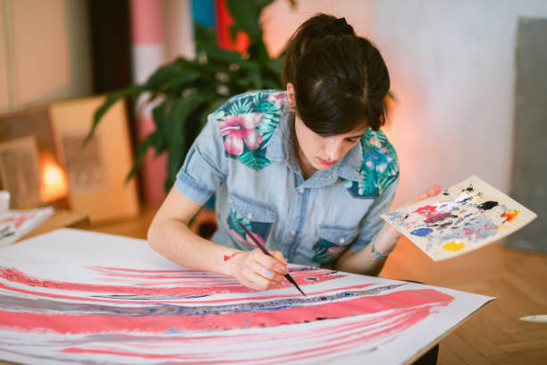 istock Female artist paint on canvas in studio 1313883877