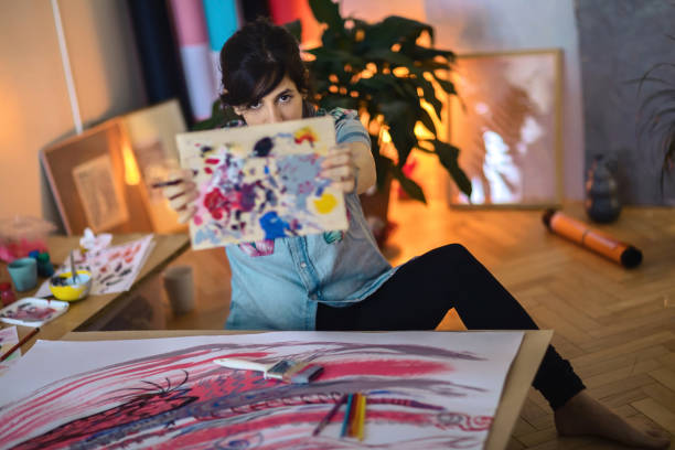 istock Female artist paint on canvas in studio 1313884014