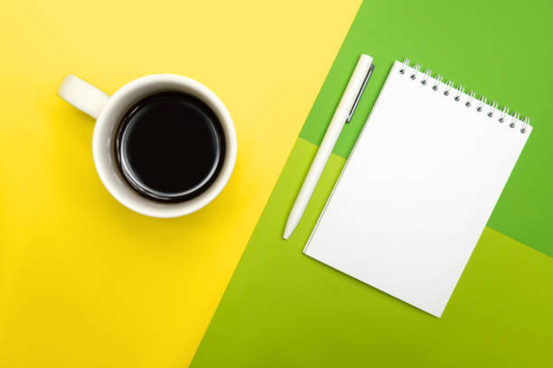 istock White pen and notepad, on a multicolored background with a cup of coffee. 1313884202