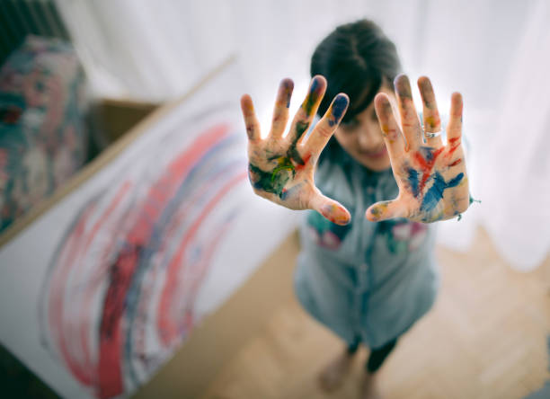 istock Female artist paint on canvas in studio 1313885281