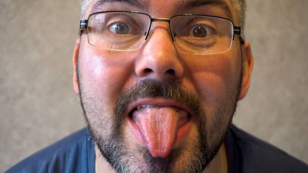 istock Man with glasses showing tongue 1313885801