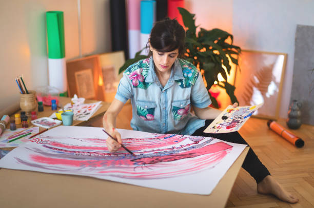 istock Female artist paint on canvas in studio 1313886658