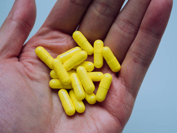 istock View from above of a hand with yellow pills with copy space 1313887885
