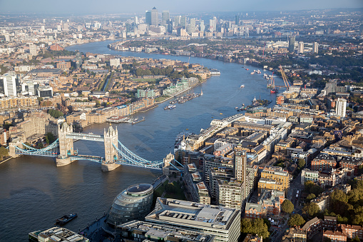 Aerial view of London with office buildings, Thames River, skyscrapers of Docklands, Canary Wharf are visible in the background, England.