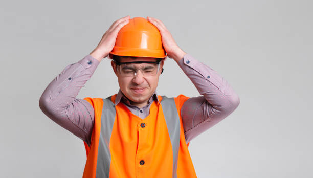 istock young engineer architect clutching his head in helmet on grey studio background, foreman shocked 1313893648