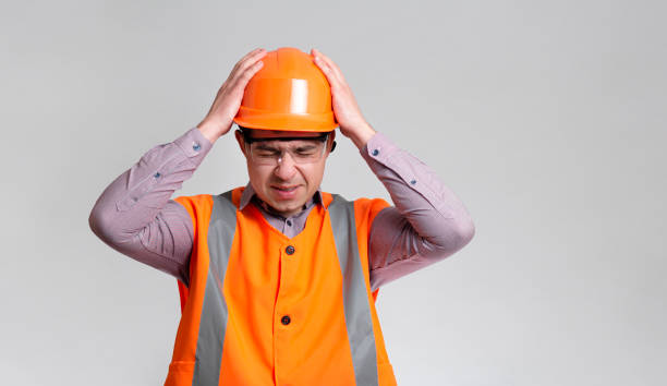 istock young engineer architect clutching his head in helmet on grey studio background, foreman shocked 1313893657