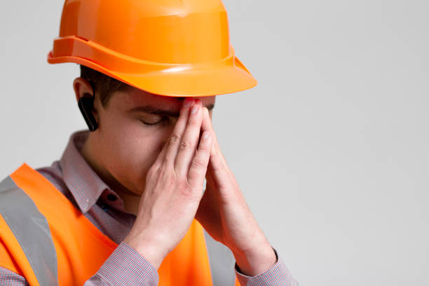 istock tired frustrated engineer bowed head in emotional stress on grey background, foreman thinking about problem in work 1313893720