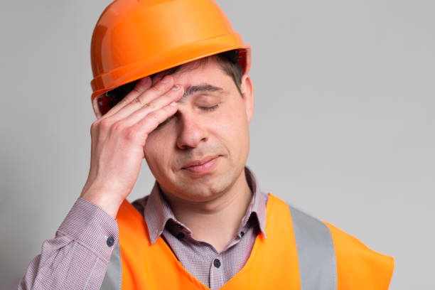 istock tired frustrated engineer bowed head in emotional stress on grey background, foreman thinking about problem in work 1313893761