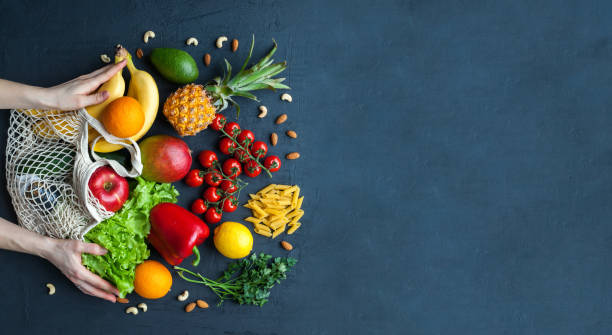 istock Hands holding a string bag with healthy vegetarian food 1313894027