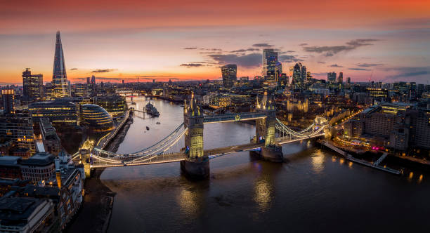 Panoramic, aerial view to the illuminated cityscape of London Panoramic, aerial view to the cityscape of London with Tower Bridge and the illuminated skyscrapers of the city during dusk, United Kingdom london england photos stock pictures, royalty-free photos & images