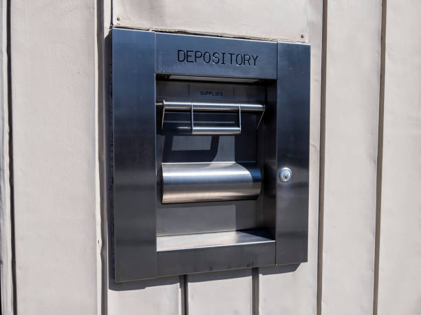 view of a metal depository box on the outside of a bank - night deposit box imagens e fotografias de stock