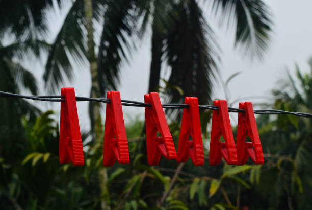 Red plastic clothespin hanging on a wire unique photo