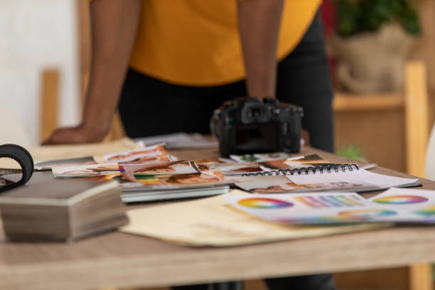 istock Photographer going through photographs at her office 1313898750