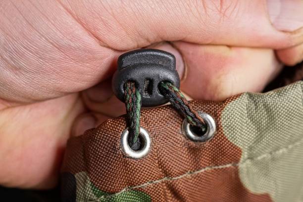 istock hand holds a lace and a black plastic carabiner 1313898822