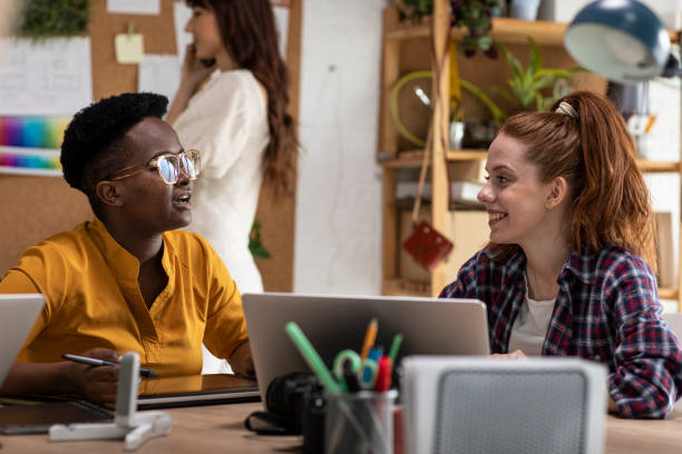 istock Coworkers chatting while working at the office together 1313899249