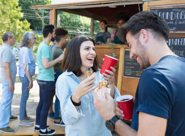 istock Young couple having some food outside 1313899452