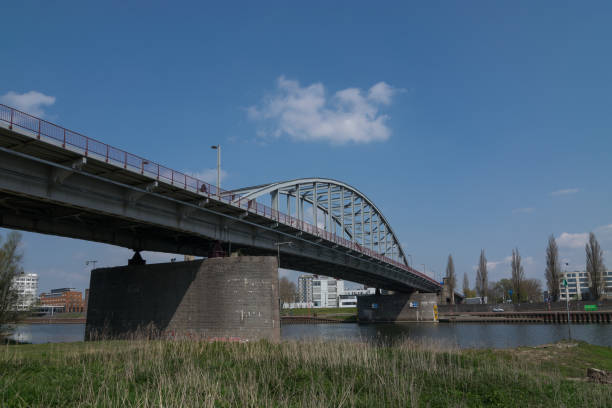 The famous John Frost bridge in Arnhem at a beautiful spring day This famous bridge from the movie A Bridge to Far dominates the Arnhem cityscape. arnhem photos stock pictures, royalty-free photos & images