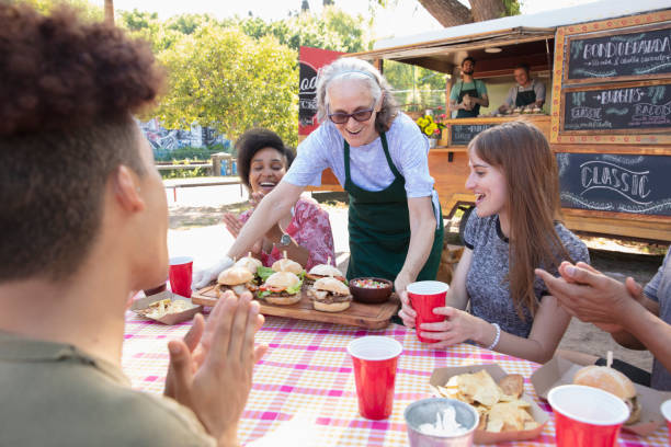 istock waitress serving food outside 1313900084