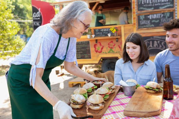 istock waitress serving food outside 1313900097