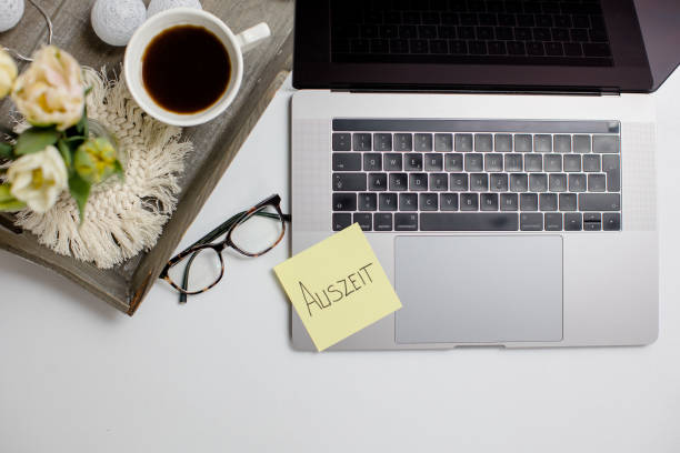 istock Office desk - laptop with sticky note with word 