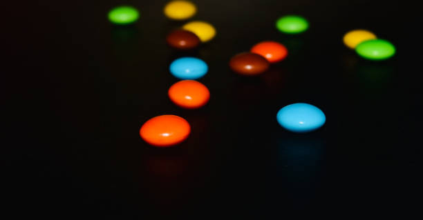 istock Colourful candies on black surface unique photo 1313900594