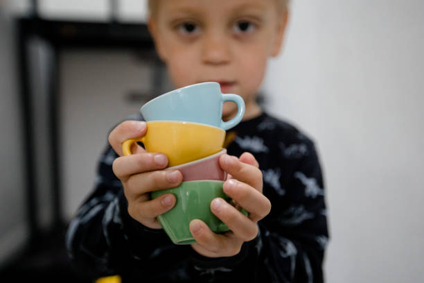 istock Boys holds children's tea cup in his hand 1313900613