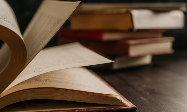 istock Opened book on a pile of old books.  Study education concept 1313904377