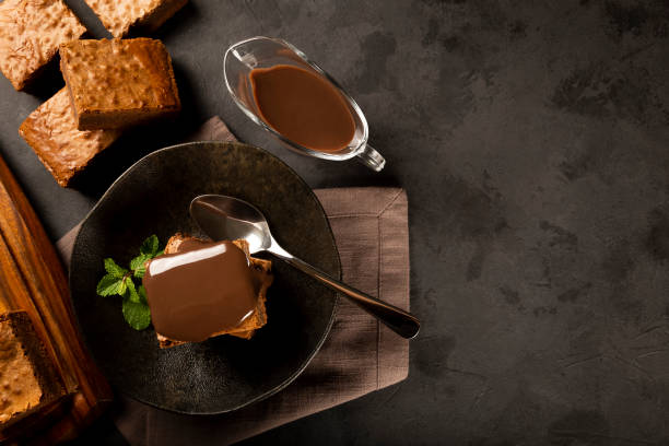 istock Chocolate brownies with chocolate sauce and mint leaves. 1313907144