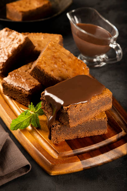 istock Chocolate brownies with chocolate sauce and mint leaves. 1313907155