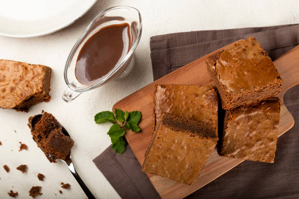 istock Chocolate brownies with chocolate sauce and mint leaves. 1313907188