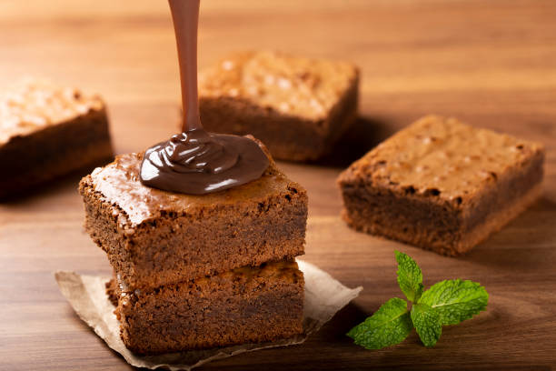 istock Chocolate brownies with chocolate sauce and mint leaves. 1313907200
