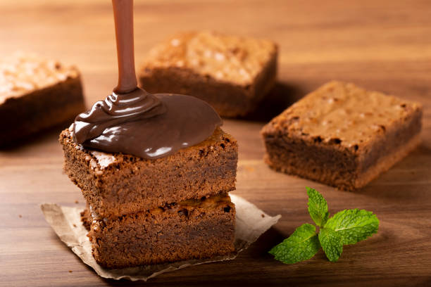 istock Chocolate brownies with chocolate sauce and mint leaves. 1313907225