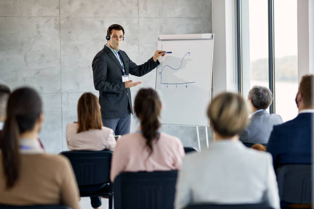istock Executive manager with face mask talking about business progress during seminar in board room. 1313909807