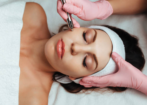 istock beautician in pink gloves doing microdermabrasion 1313910876